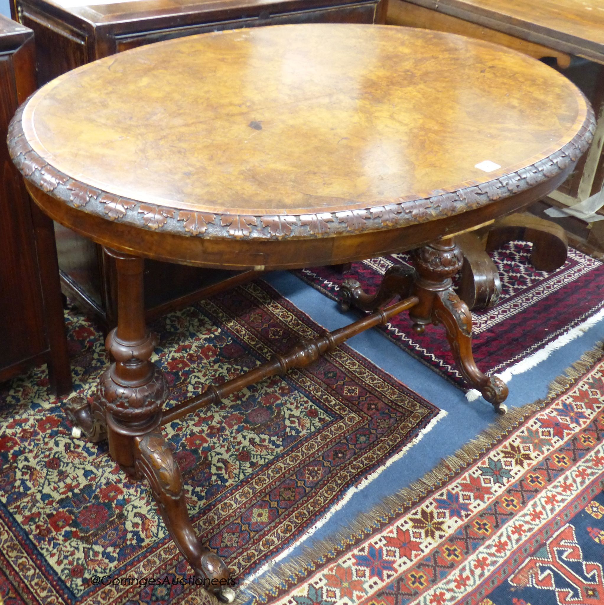 A Victorian oval tulip banded burr walnut centre table, width 104cm, depth 66cm, height 70cm